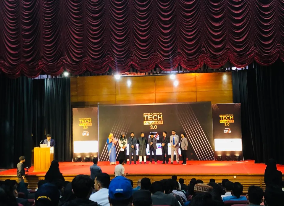 Winners on stage with branded backdrop — National Tech Awards 3.0